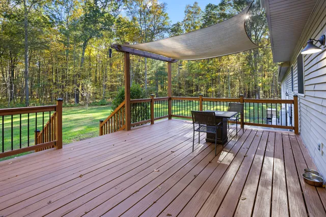 a view of a wooden deck with a yard
