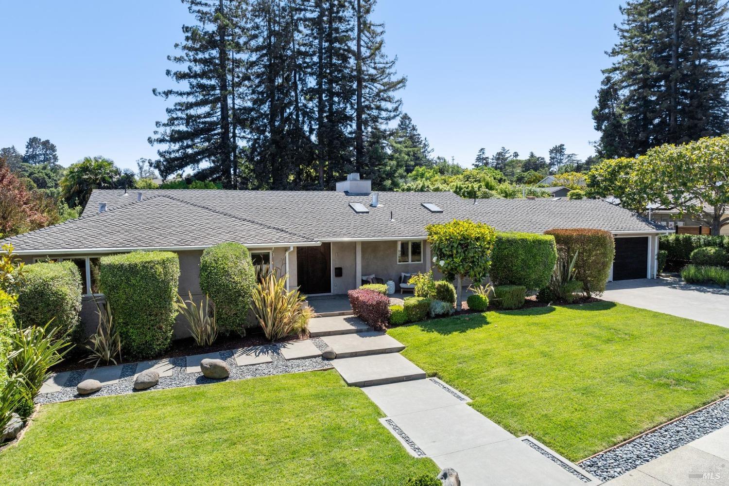 a view of a house with a yard patio and fire pit