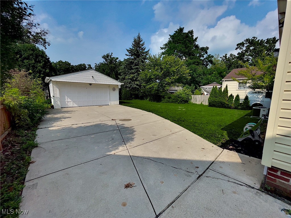 24000 Knickerbocker Road Bay Village, OH 44140 - Photo 4 of 27 Garage featuring a lawn