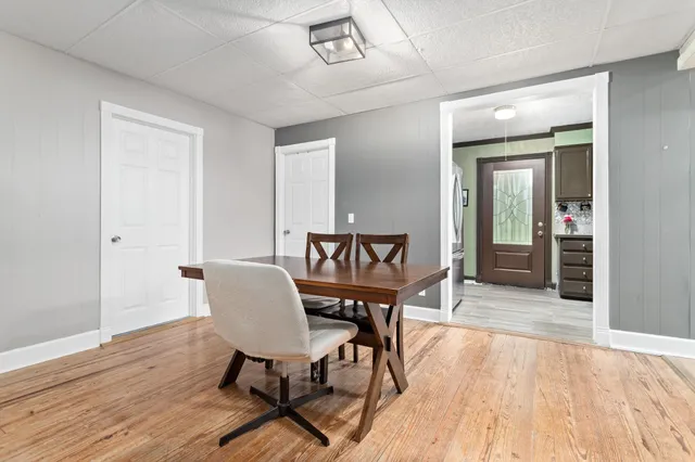 a view of a dining room with furniture and wooden floor