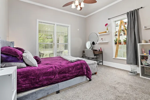 a bedroom with a bed and a window