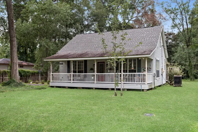 a view of a house with a yard and sitting area