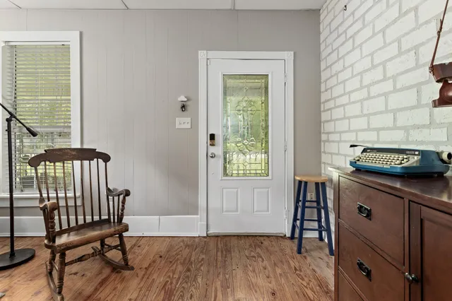a kitchen with a wooden floor and a table