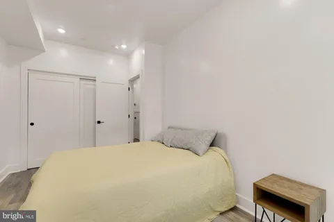 a bedroom with a bed and a chair