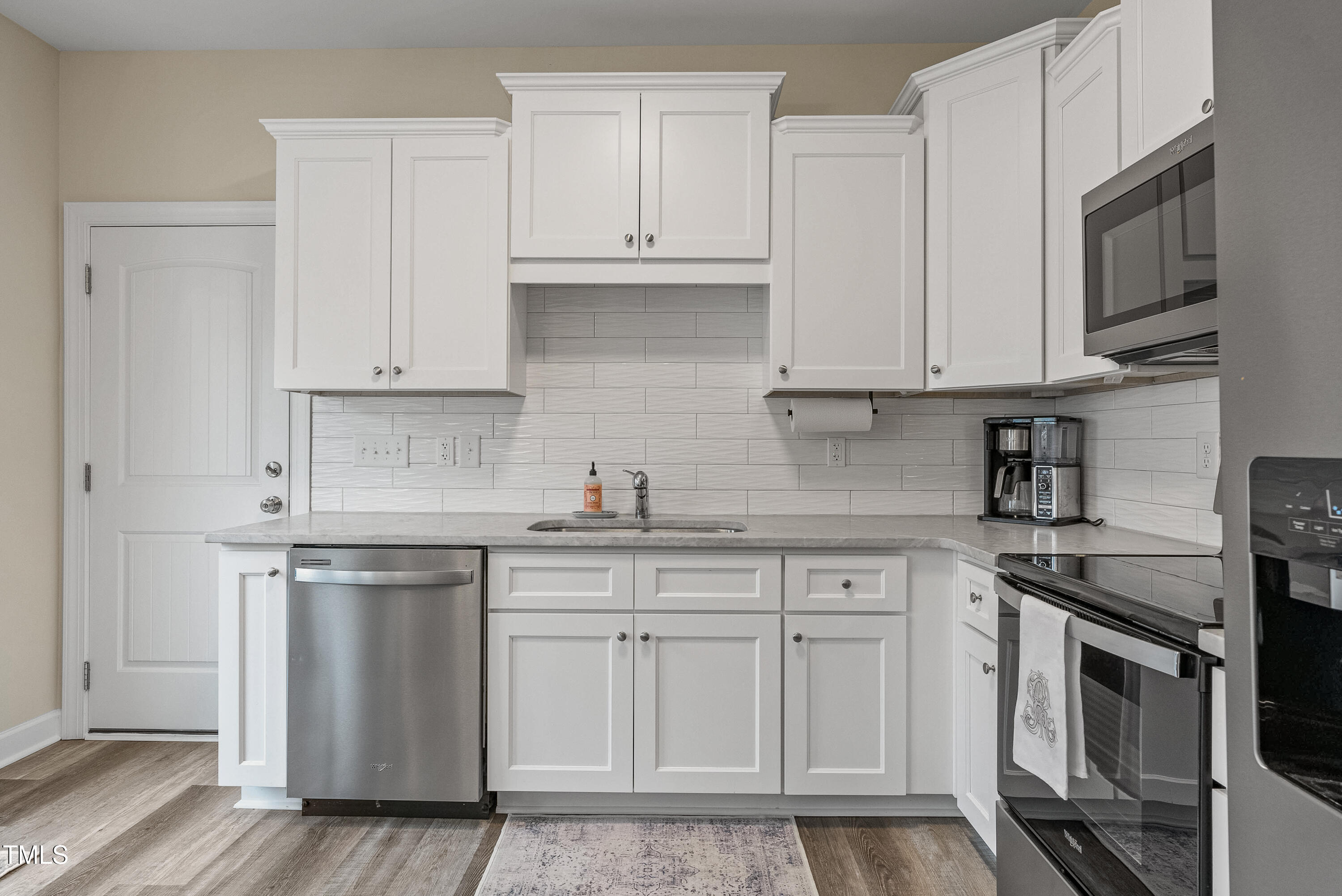 5711 Piney Grove Road Angier, NC 27501 - Photo 11 of 35 a kitchen with white cabinets stainless steel appliances and sink