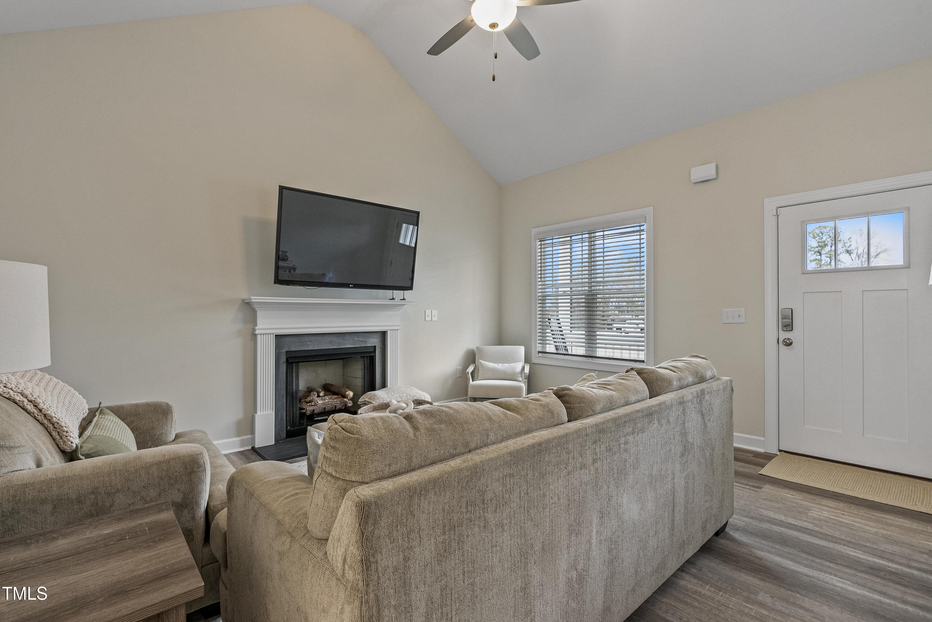 5711 Piney Grove Road Angier, NC 27501 - Photo 17 of 35 a living room with furniture a fireplace and a flat screen tv