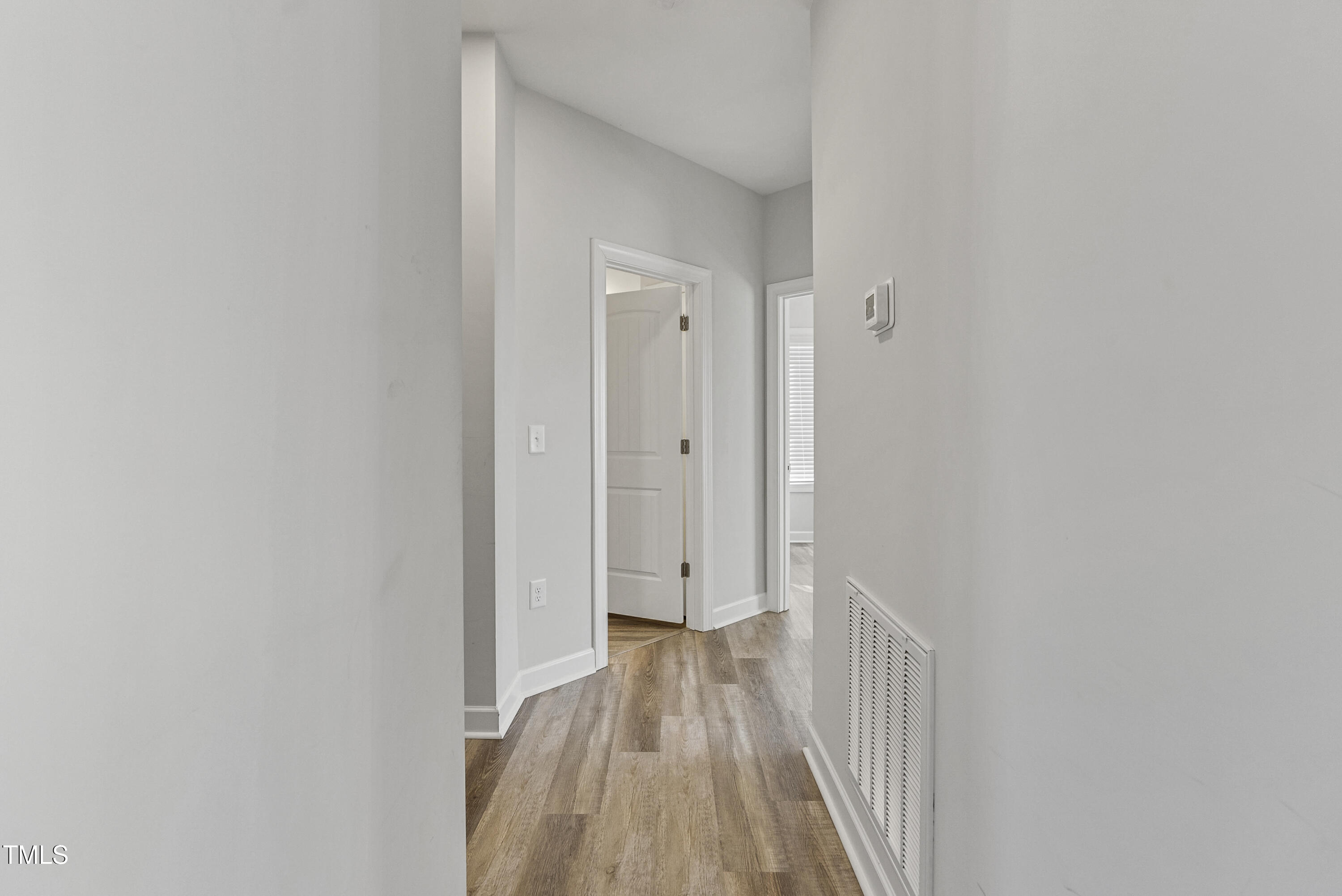 5711 Piney Grove Road Angier, NC 27501 - Photo 19 of 35 a view of a hallway with wooden floor and a bathroom