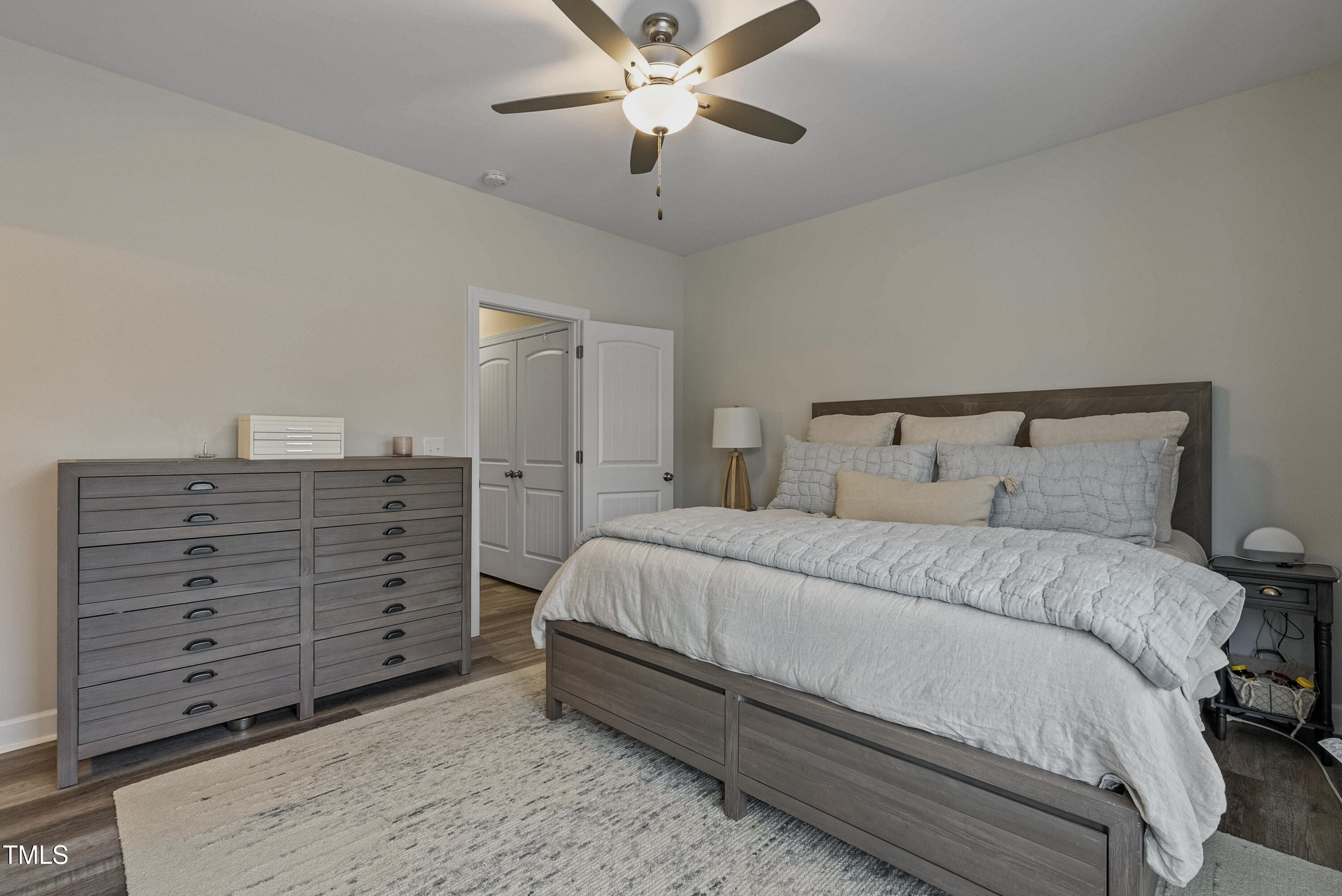 5711 Piney Grove Road Angier, NC 27501 - Photo 21 of 35 a bedroom with a bed and a ceiling fan