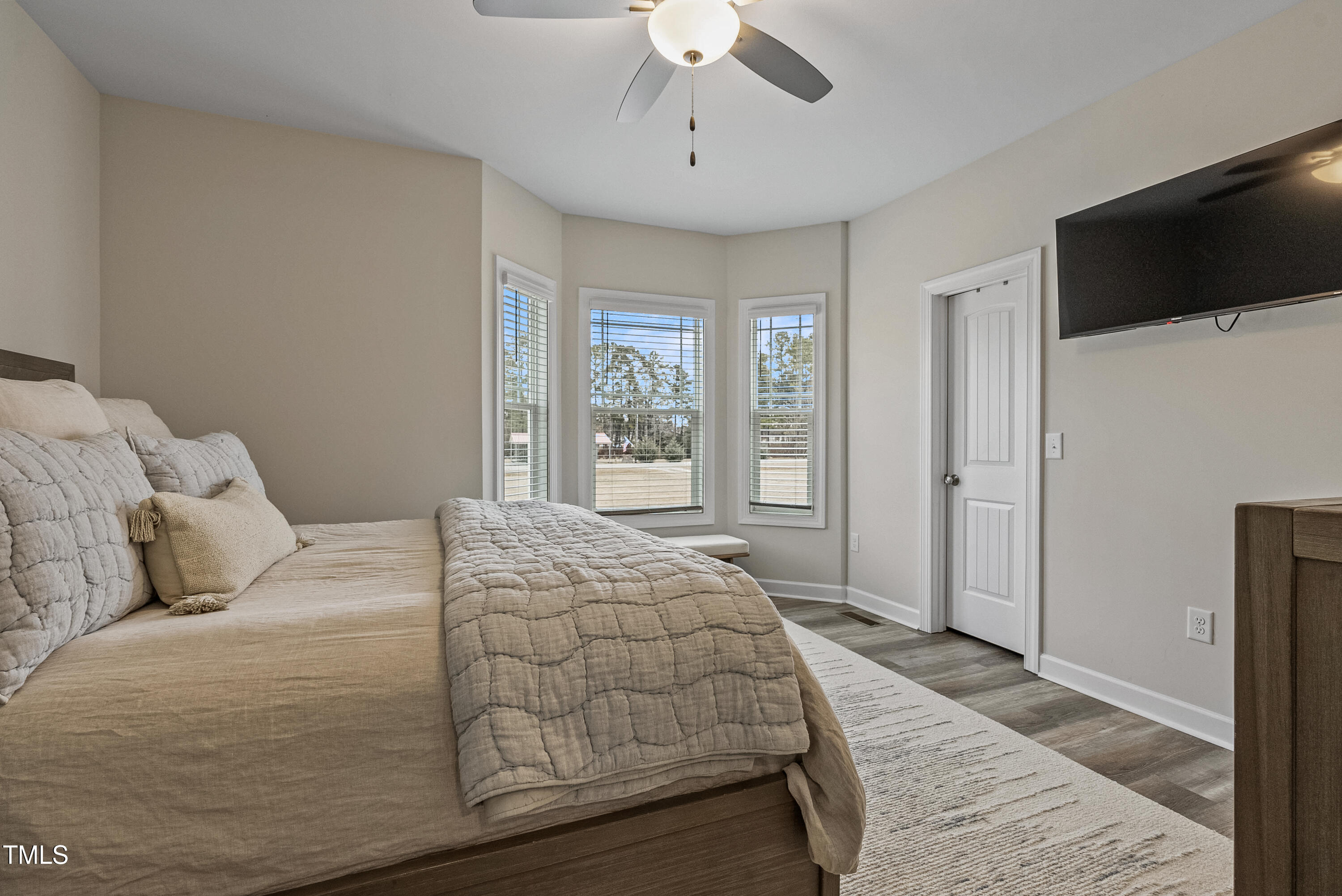 5711 Piney Grove Road Angier, NC 27501 - Photo 22 of 35 a bedroom with a large bed and a flat screen tv