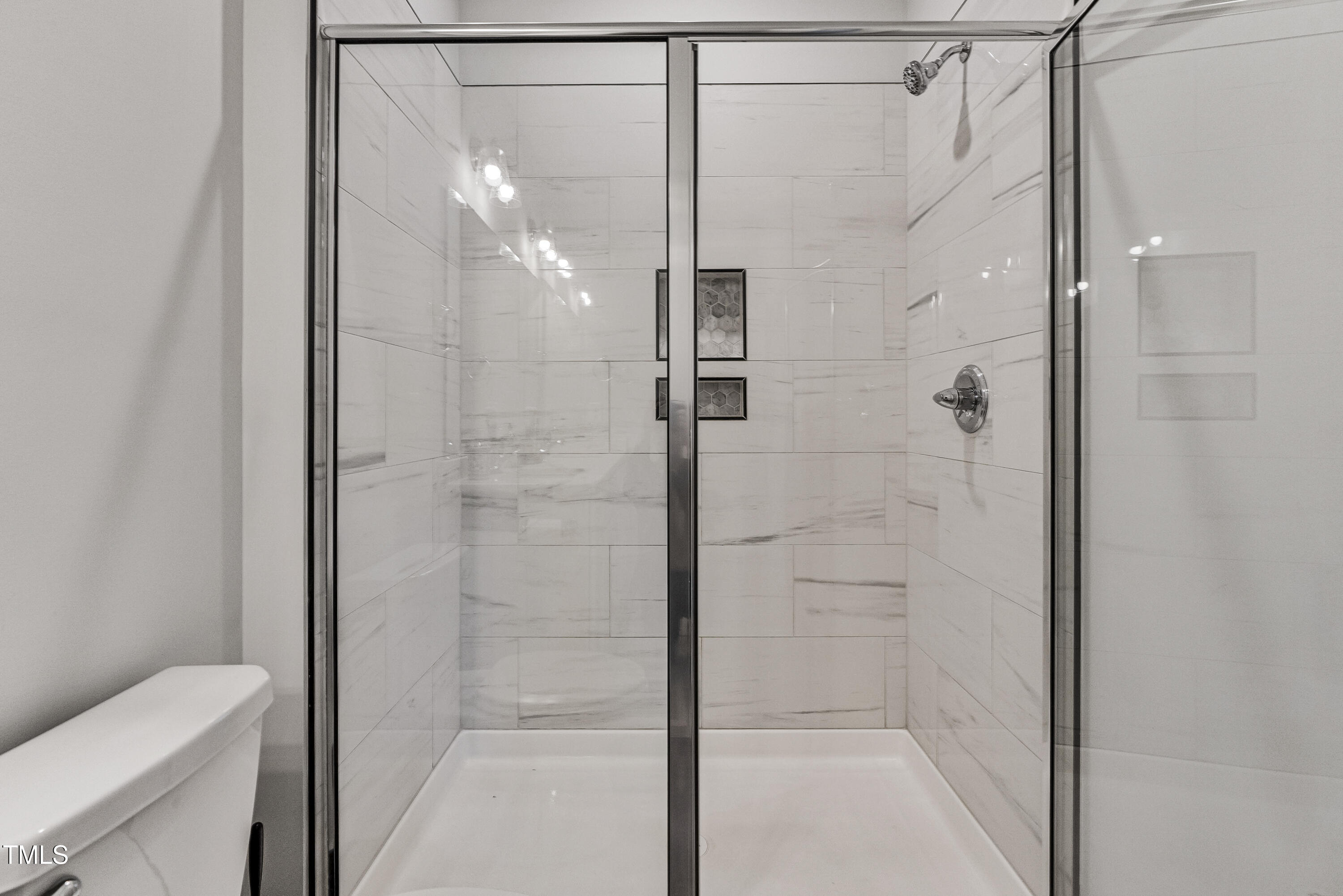 5711 Piney Grove Road Angier, NC 27501 - Photo 24 of 35 a bathroom with a glass shower door