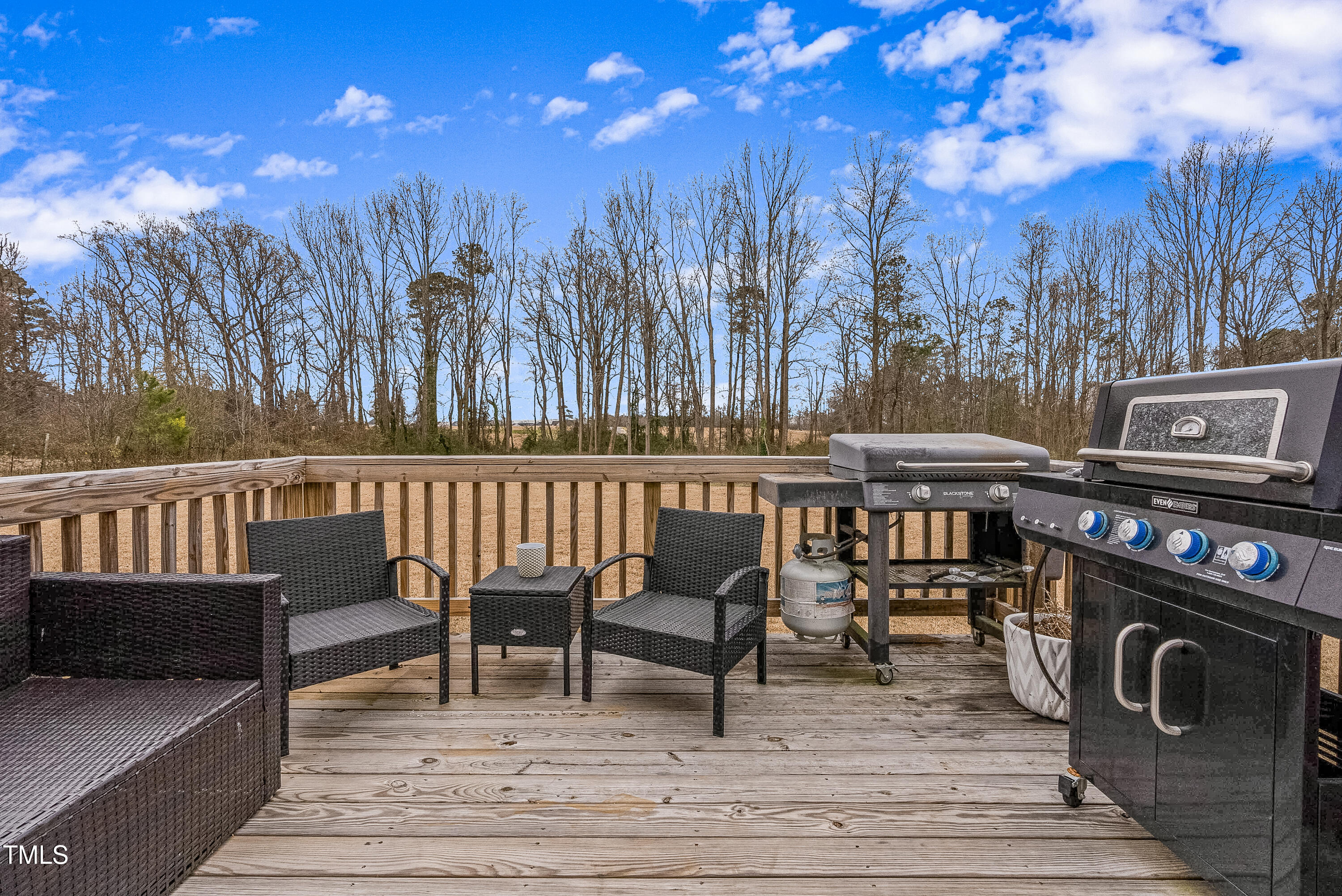5711 Piney Grove Road Angier, NC 27501 - Photo 34 of 35 a balcony with wooden floor table and chairs