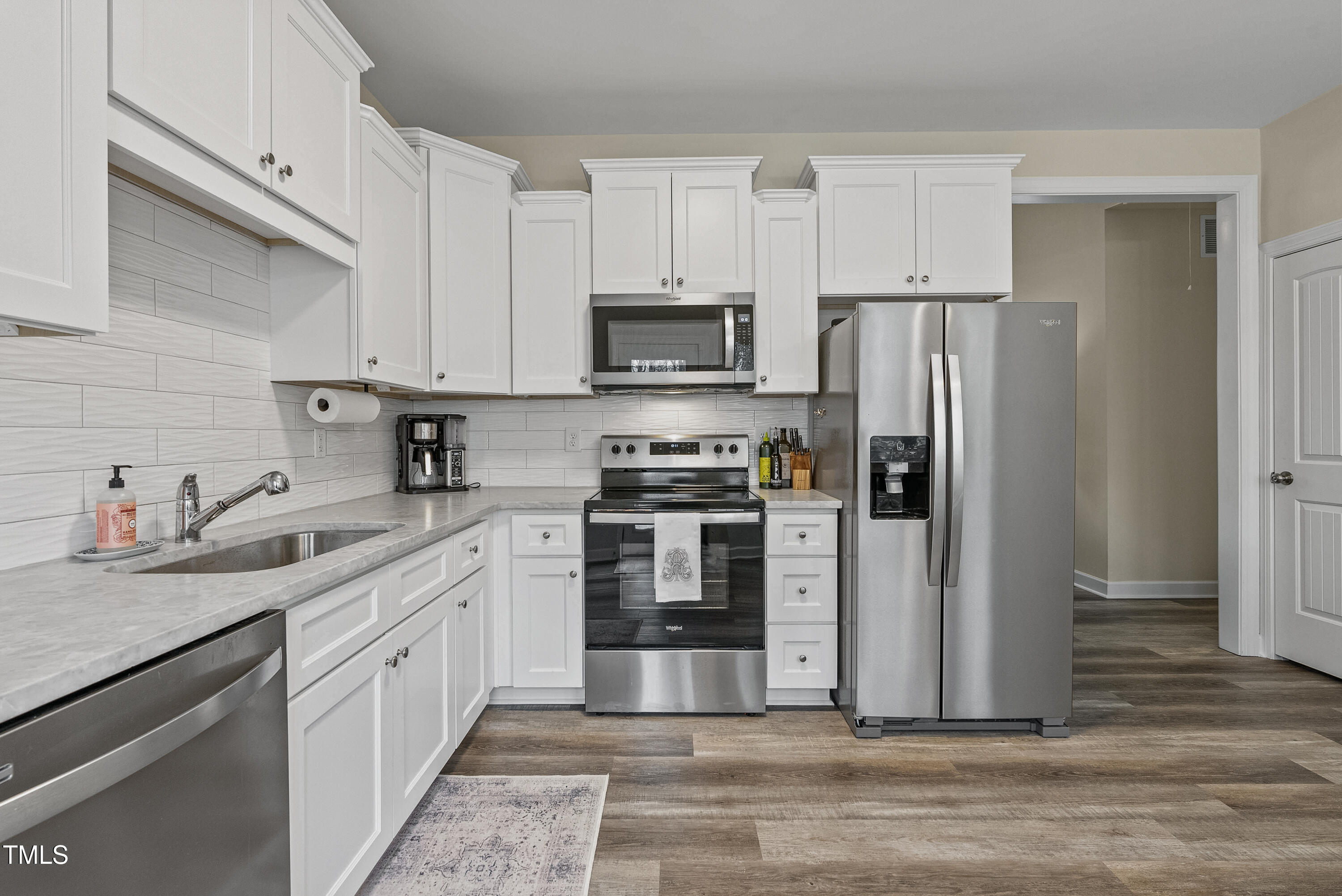 5711 Piney Grove Road Angier, NC 27501 - Photo 10 of 35 a kitchen with cabinets stainless steel appliances and a counter space