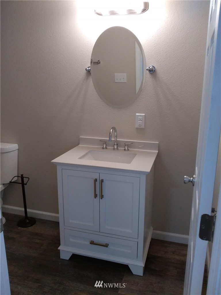 1141-1143 Magnuson Way Bremerton, WA 98310 - Photo 4 of 10 a bathroom with a sink and a mirror