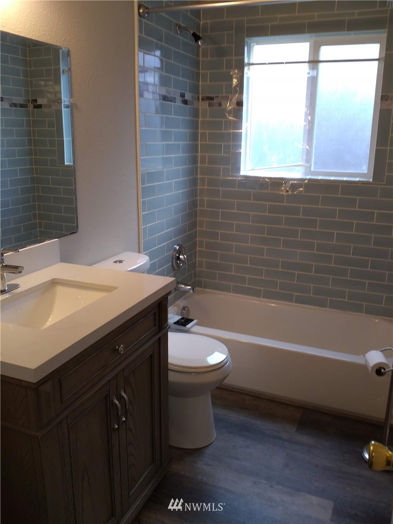 1141-1143 Magnuson Way Bremerton, WA 98310 - Photo 7 of 10 a bathroom with a sink a toilet and bathtub