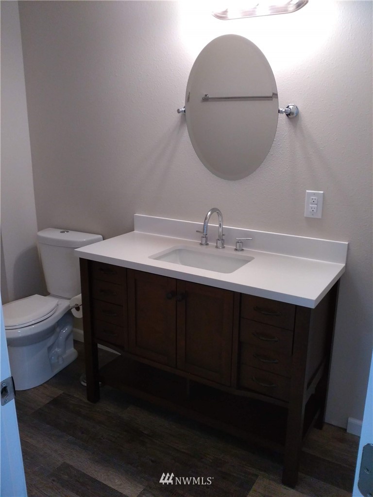 1141-1143 Magnuson Way Bremerton, WA 98310 - Photo 9 of 10 a bathroom with a sink toilet and mirror