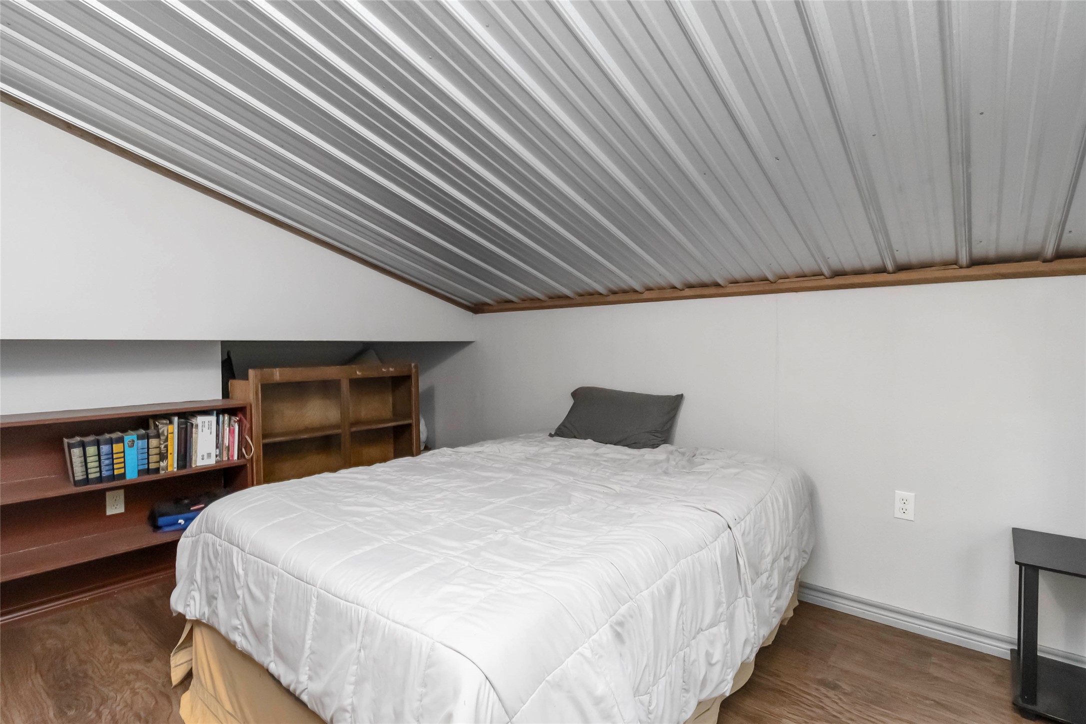 208 Old Potato Road Paige, TX 78659 - Photo 36 of 40 Apartment bedroom with vaulted ceiling and wood finished floors