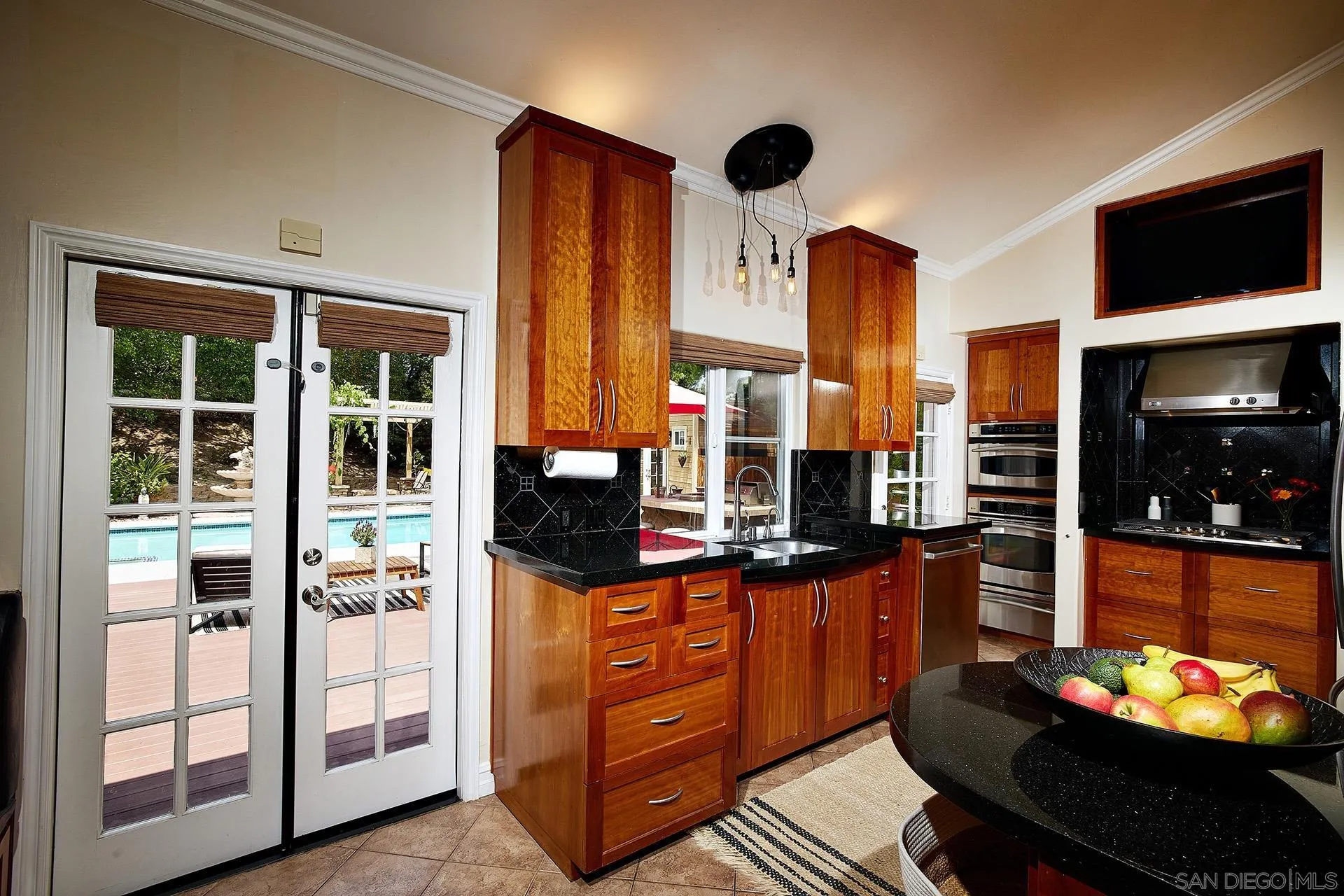 1548 Calle Violetas Encinitas, CA 92024 - Photo 23 of 47 a kitchen with stainless steel appliances kitchen island granite countertop a stove and cabinets