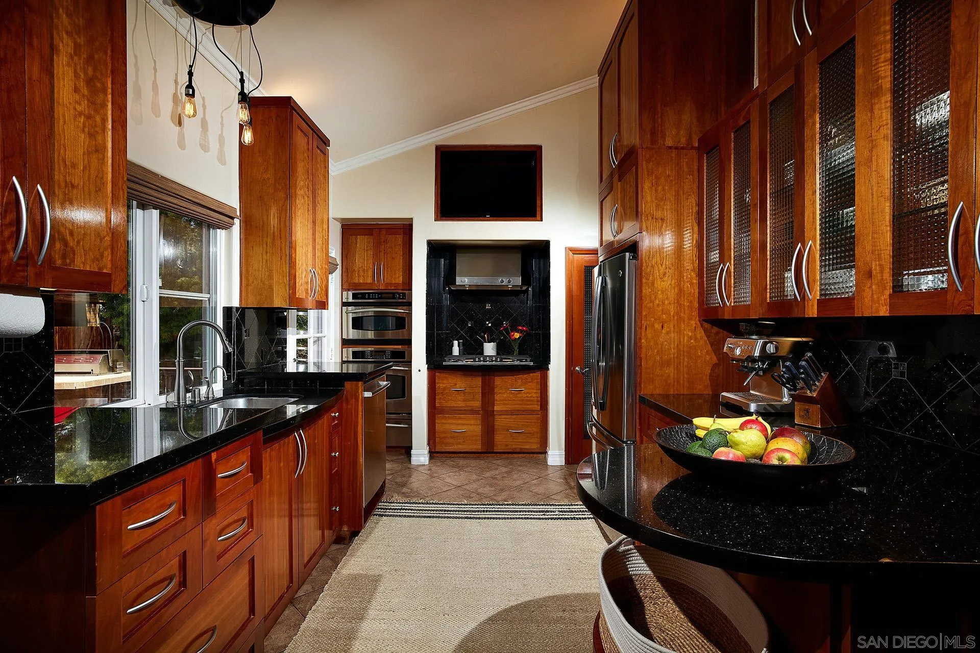 1548 Calle Violetas Encinitas, CA 92024 - Photo 24 of 47 a kitchen with stainless steel appliances kitchen island granite countertop a stove and cabinets