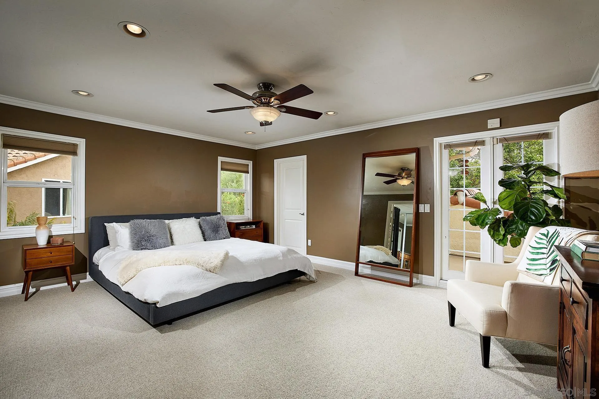 1548 Calle Violetas Encinitas, CA 92024 - Photo 26 of 47 a spacious bedroom with a bed a couch and a potted plant