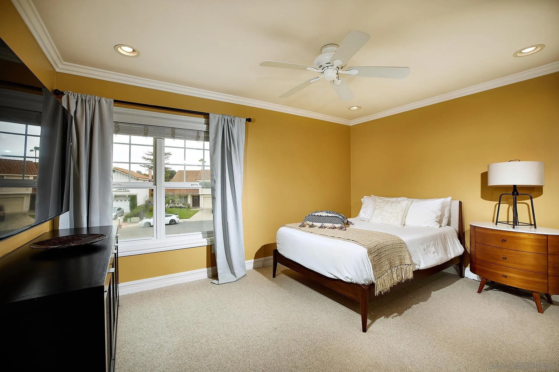 1548 Calle Violetas Encinitas, CA 92024 - Photo 32 of 47 a spacious bedroom with a bed and a lamp