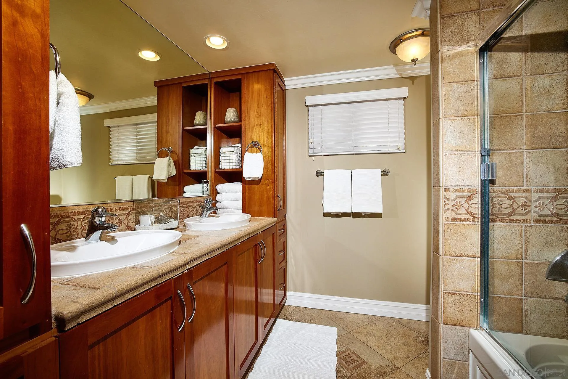 1548 Calle Violetas Encinitas, CA 92024 - Photo 34 of 47 a bathroom with a sink a mirror and a shower