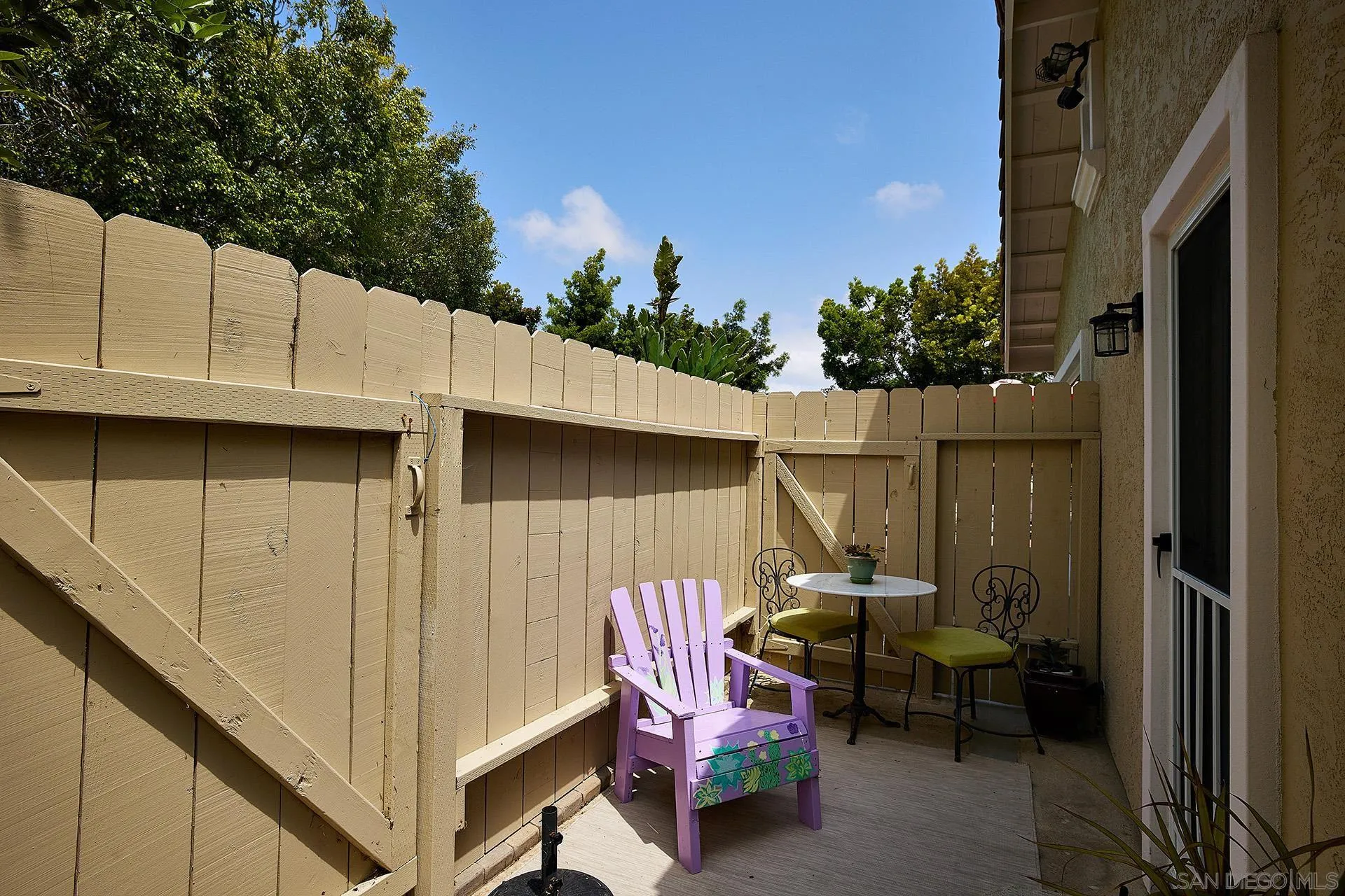 1548 Calle Violetas Encinitas, CA 92024 - Photo 36 of 47 a view of a patio with table and chairs with wooden fence