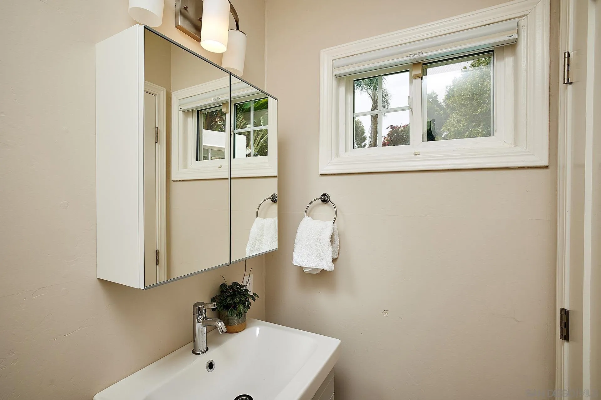 1548 Calle Violetas Encinitas, CA 92024 - Photo 44 of 47 a bathroom with a sink and a mirror