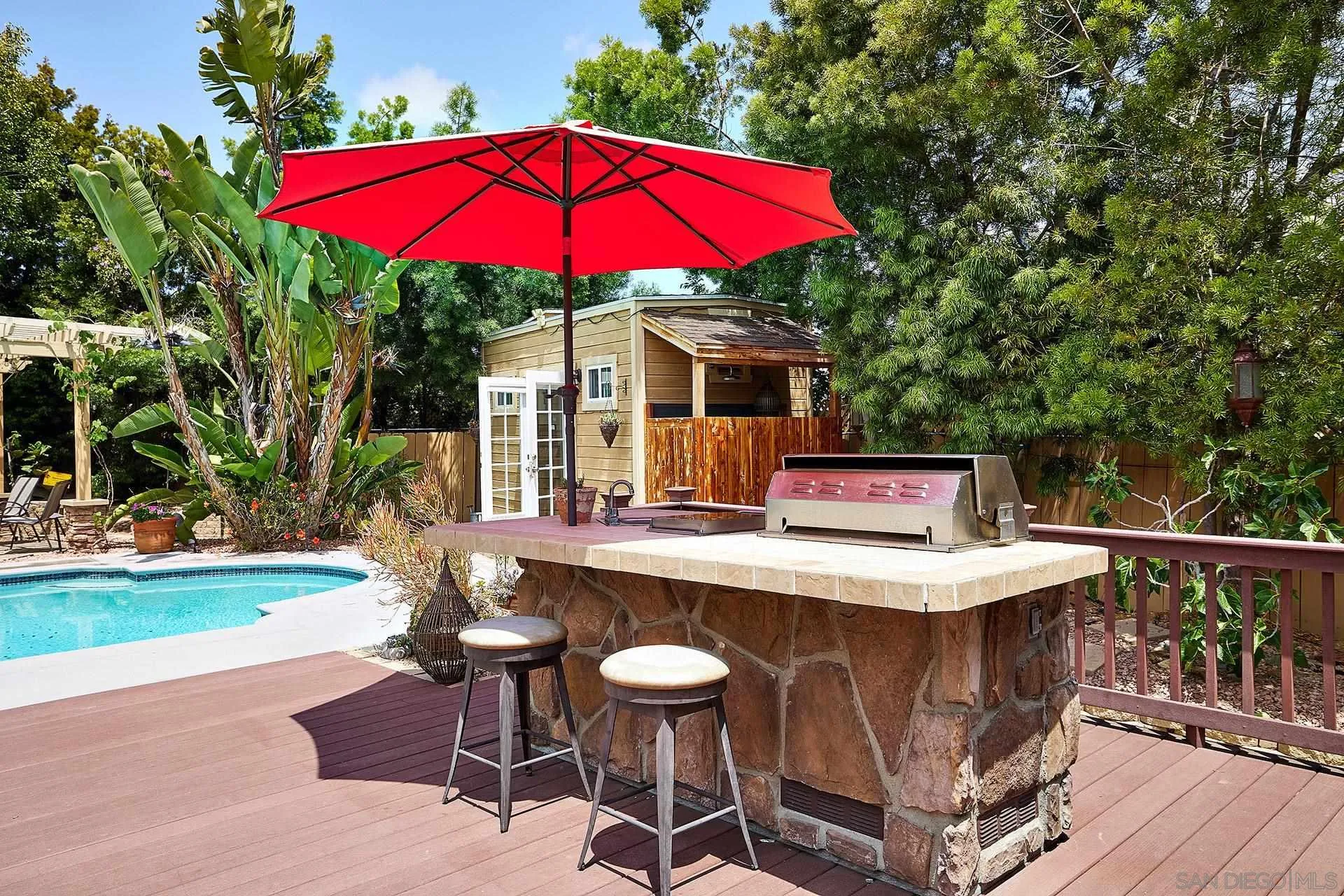 1548 Calle Violetas Encinitas, CA 92024 - Photo 10 of 47 a view of a table and chairs under an umbrella in patio
