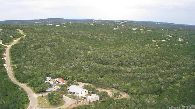 an aerial view of a house with a yard