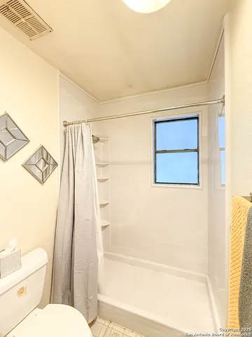 an empty room with windows and closet area