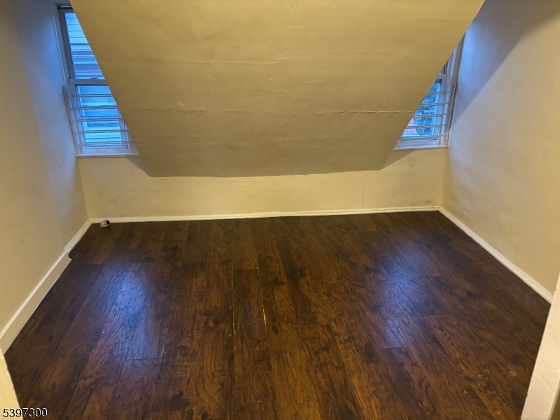 100 Harrison Place, Unit 3 Irvington, NJ 07111 - Photo 11 of 17 a view of an empty room with wooden floor