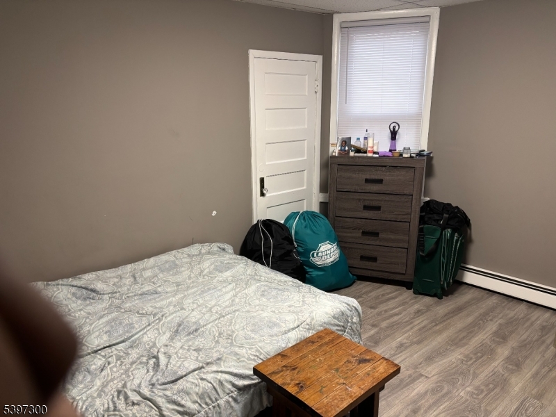 100 Harrison Place, Unit 3 Irvington, NJ 07111 - Photo 14 of 17 a bedroom with a bed and a dresser