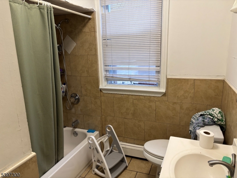 100 Harrison Place, Unit 3 Irvington, NJ 07111 - Photo 16 of 17 a bathroom with a sink and mirror with toilet