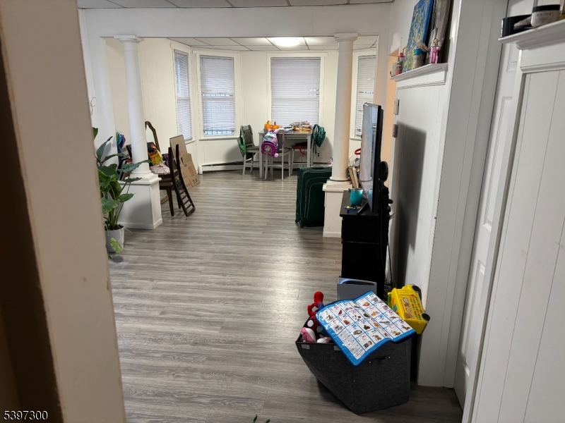 100 Harrison Place, Unit 3 Irvington, NJ 07111 - Photo 17 of 17 a living room with furniture and a wooden floor