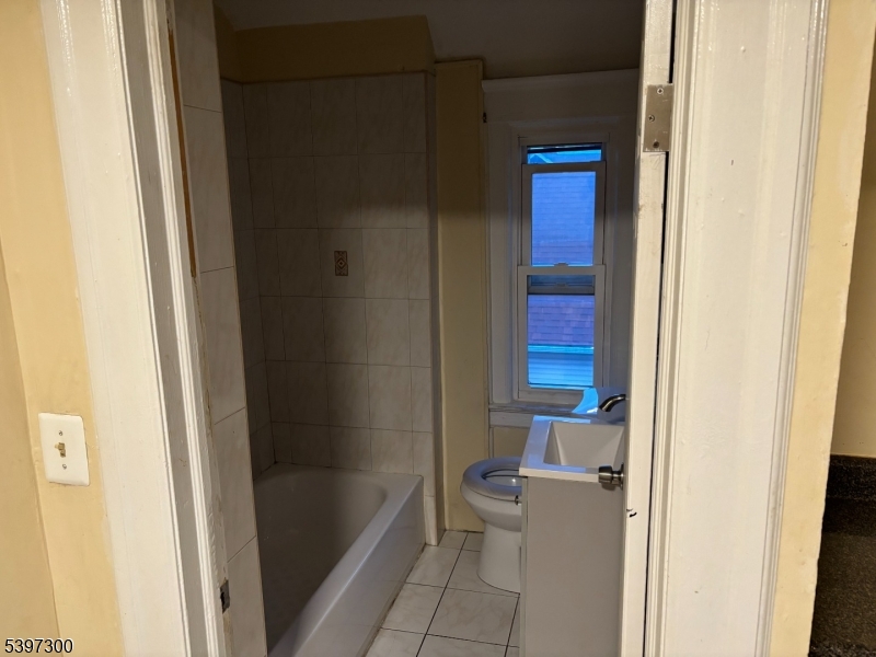 100 Harrison Place, Unit 3 Irvington, NJ 07111 - Photo 8 of 17 a bathroom with a bathtub and a toilet