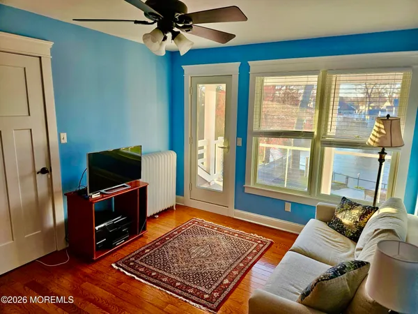 a living room with furniture rug and a flat screen tv