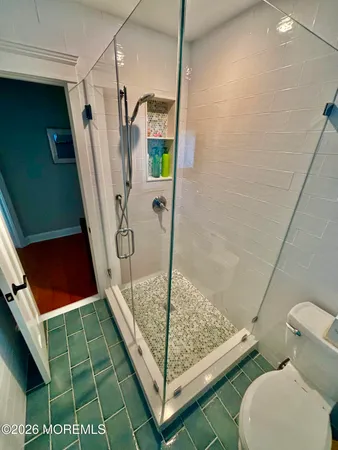 a bathroom with a toilet and a shower