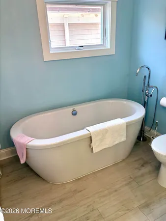 a white bath tub sitting next to a white sink