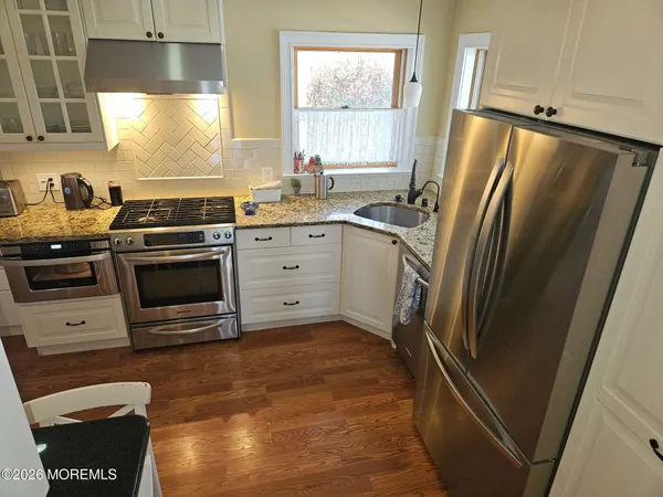 a kitchen with a sink a refrigerator and window