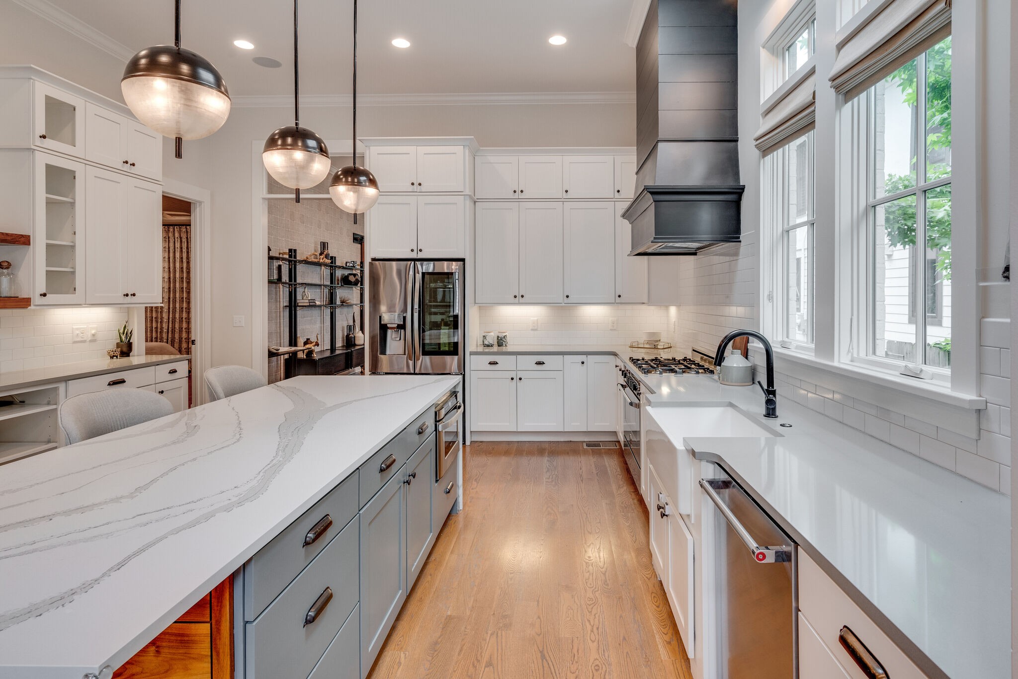 853 B Bradford Avenue Nashville, TN 37204 - Photo 15 of 49 a large kitchen with kitchen island a large counter space a sink appliances and windows