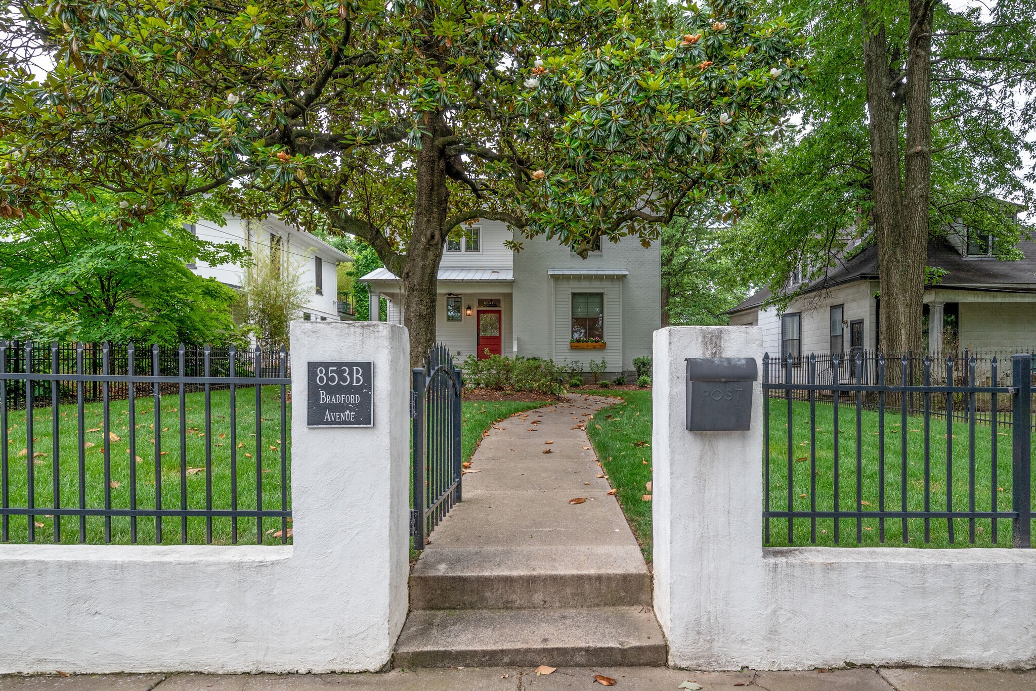 853 B Bradford Avenue Nashville, TN 37204 - Photo 2 of 49 a front view of a house with a garden and plants