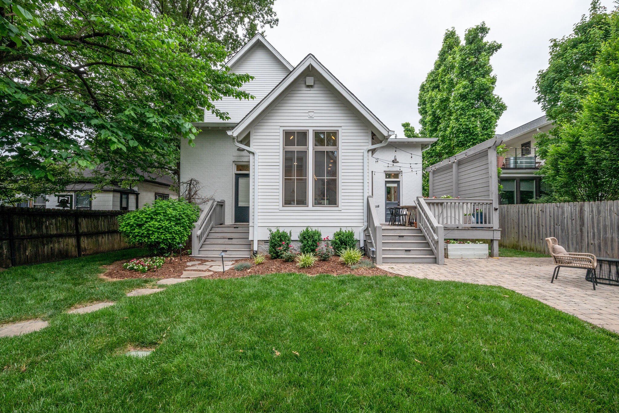853 B Bradford Avenue Nashville, TN 37204 - Photo 47 of 49 a front view of a house with garden and a tree