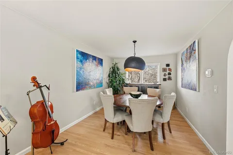 a view of a dining room with furniture wooden floor and chandelier