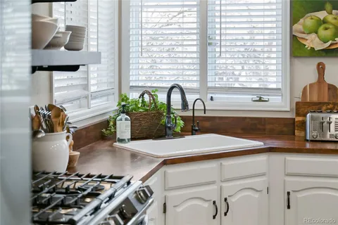 a kitchen with a sink cabinets and window