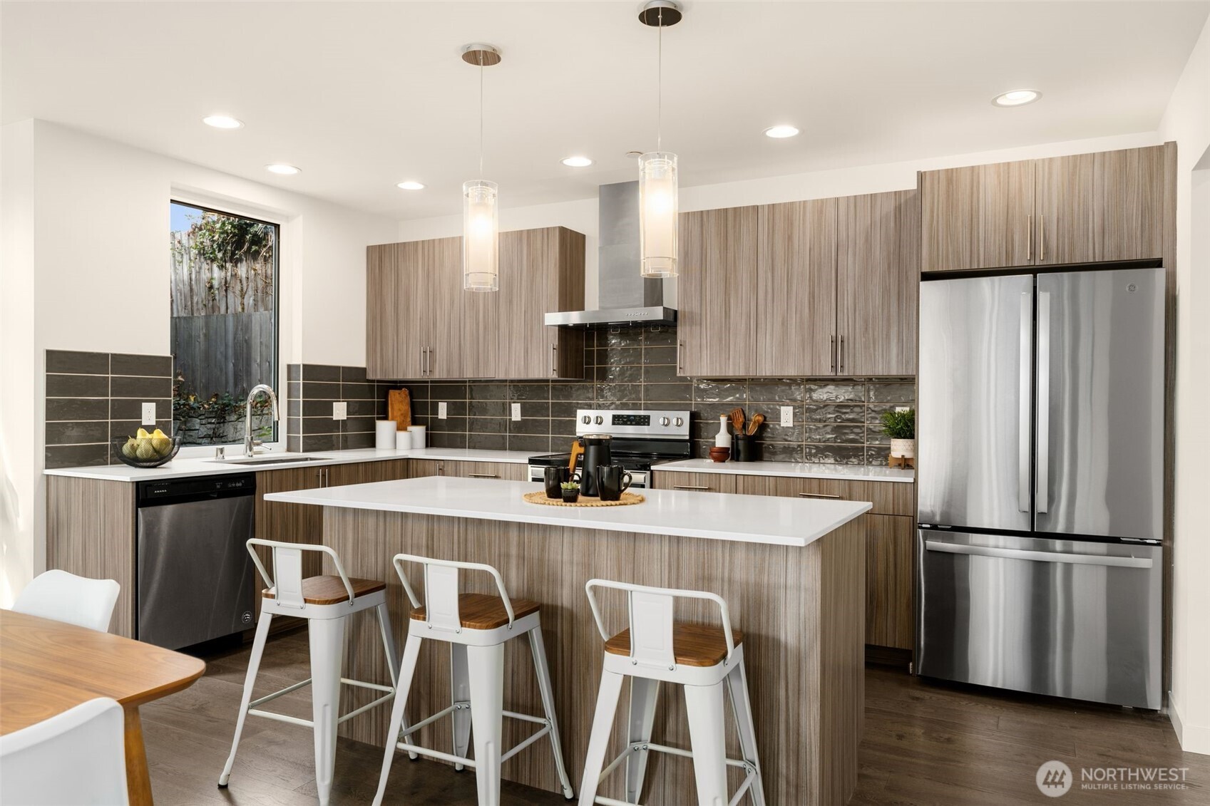 6012 South 127th Lane Seattle, WA 98178 - Photo 13 of 35 a kitchen with stainless steel appliances granite countertop a refrigerator a stove a sink a dining table and chairs