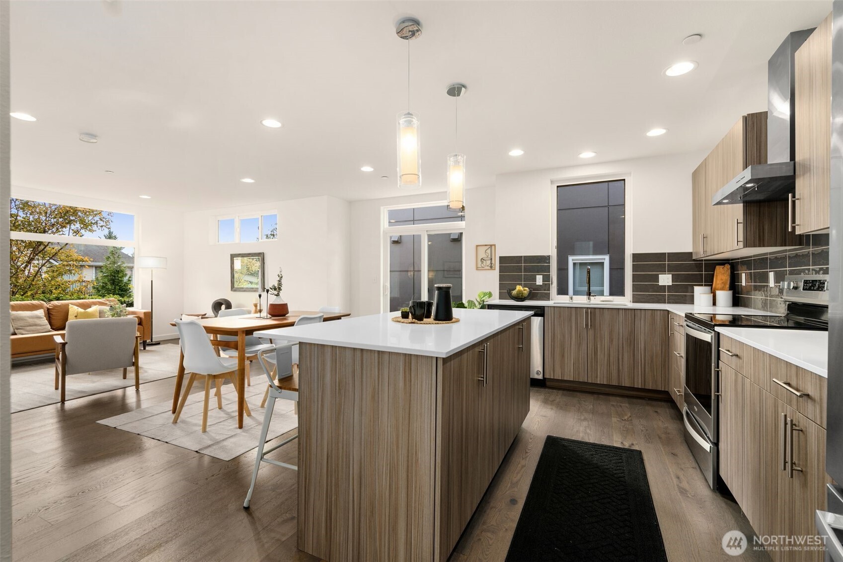 6012 South 127th Lane Seattle, WA 98178 - Photo 15 of 35 a kitchen with a sink a counter top space a large window and stainless steel appliances