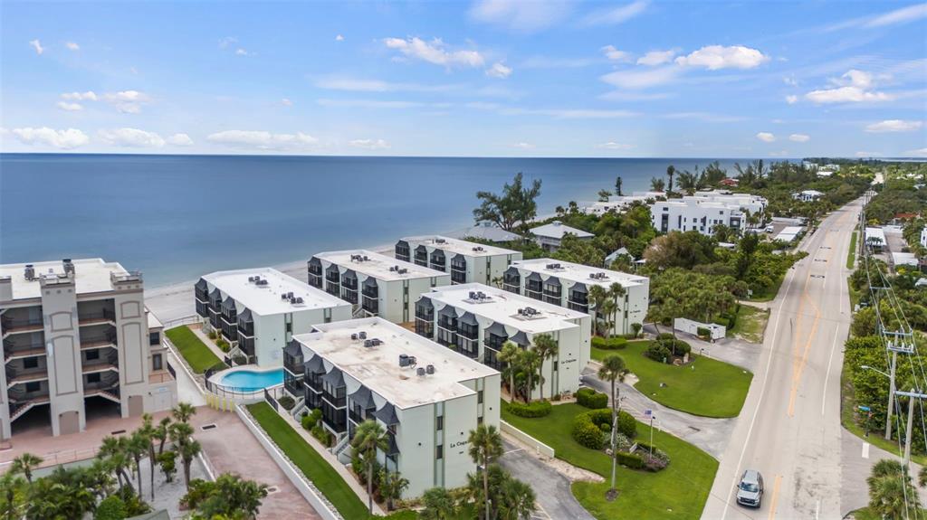 an aerial view of multiple houses with yard