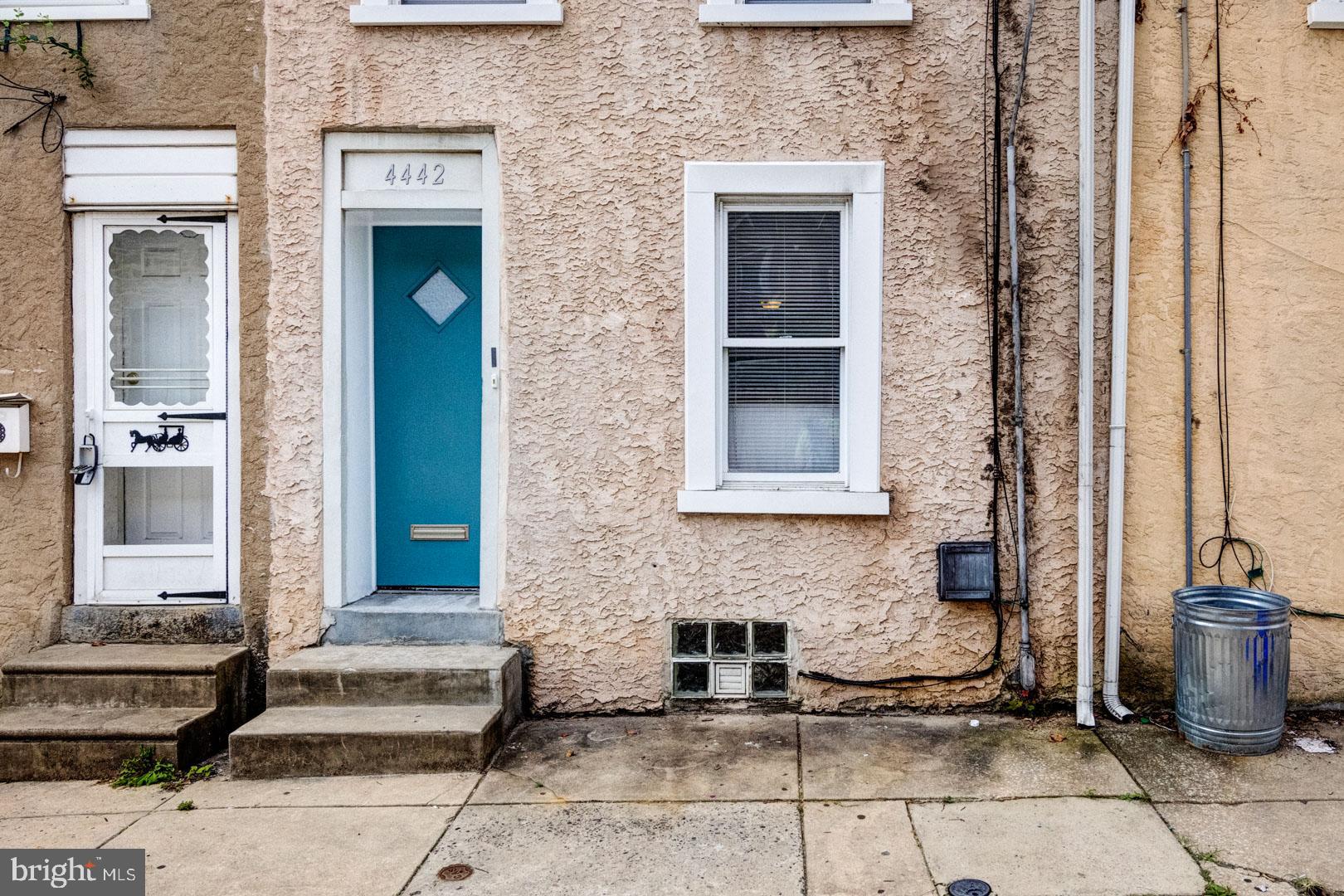 a front view of a house with a couple of potted plants