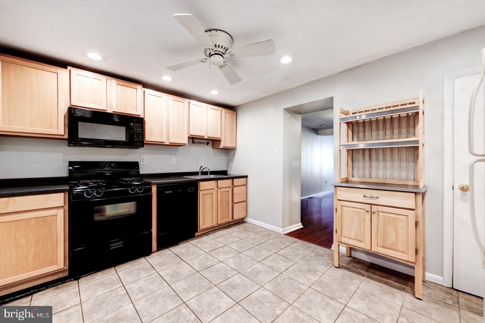 4442 Baker Street Philadelphia, PA 19127 - Photo 12 of 23 a kitchen with stainless steel appliances granite countertop a refrigerator stove and sink