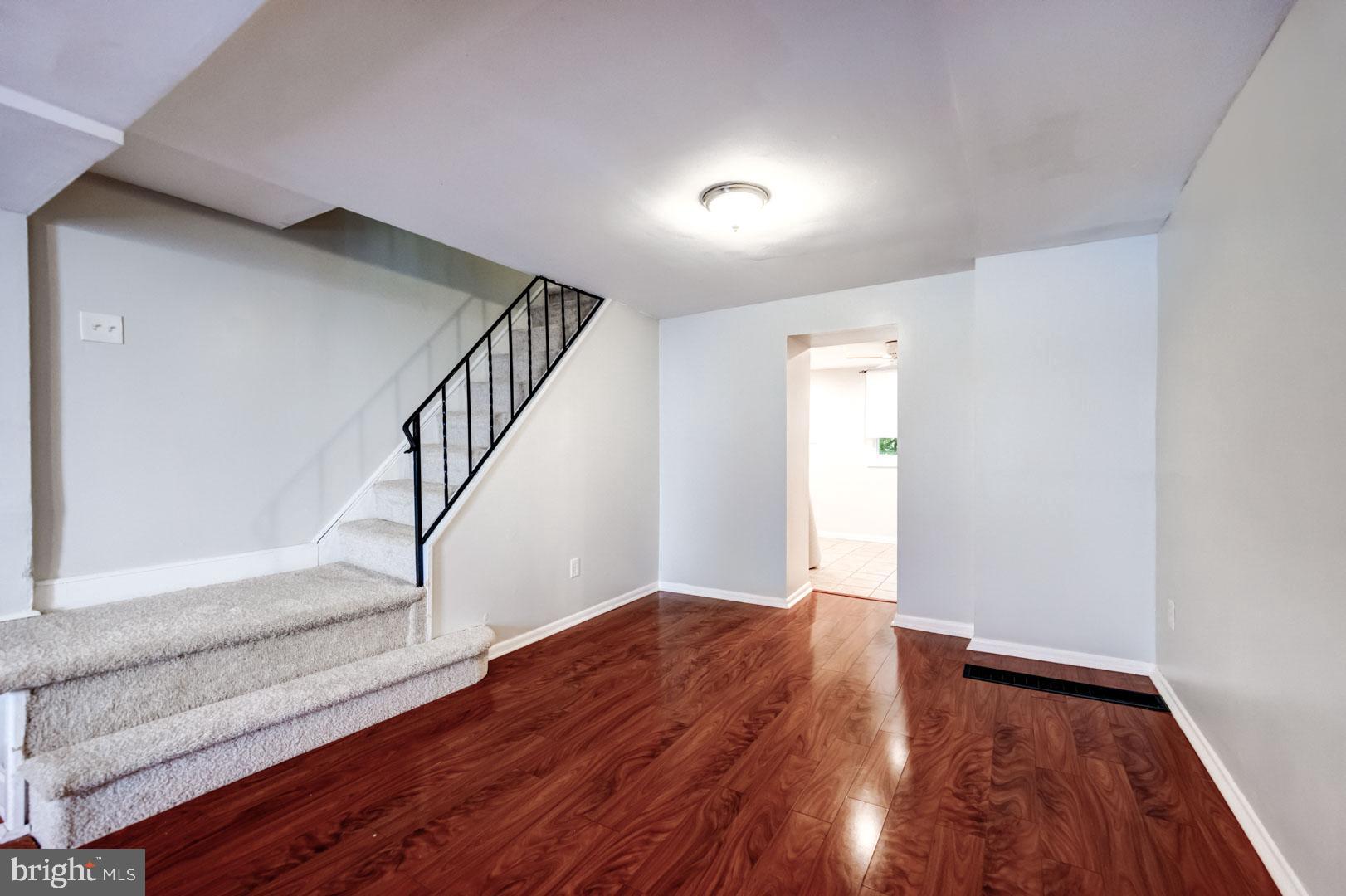 4442 Baker Street Philadelphia, PA 19127 - Photo 7 of 23 a view of empty room with wooden floor and fan